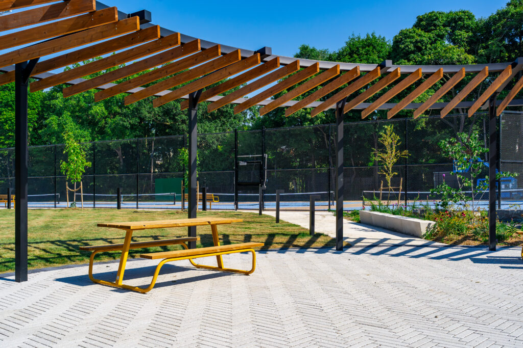 An outdoor seating area beside tennis courts.