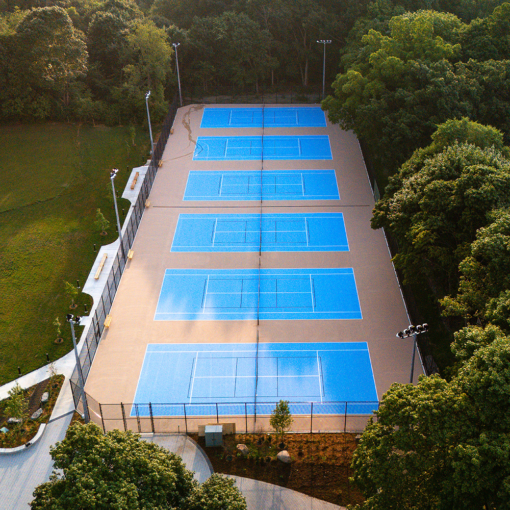 Aerial view of tennis courts with a blue surface.